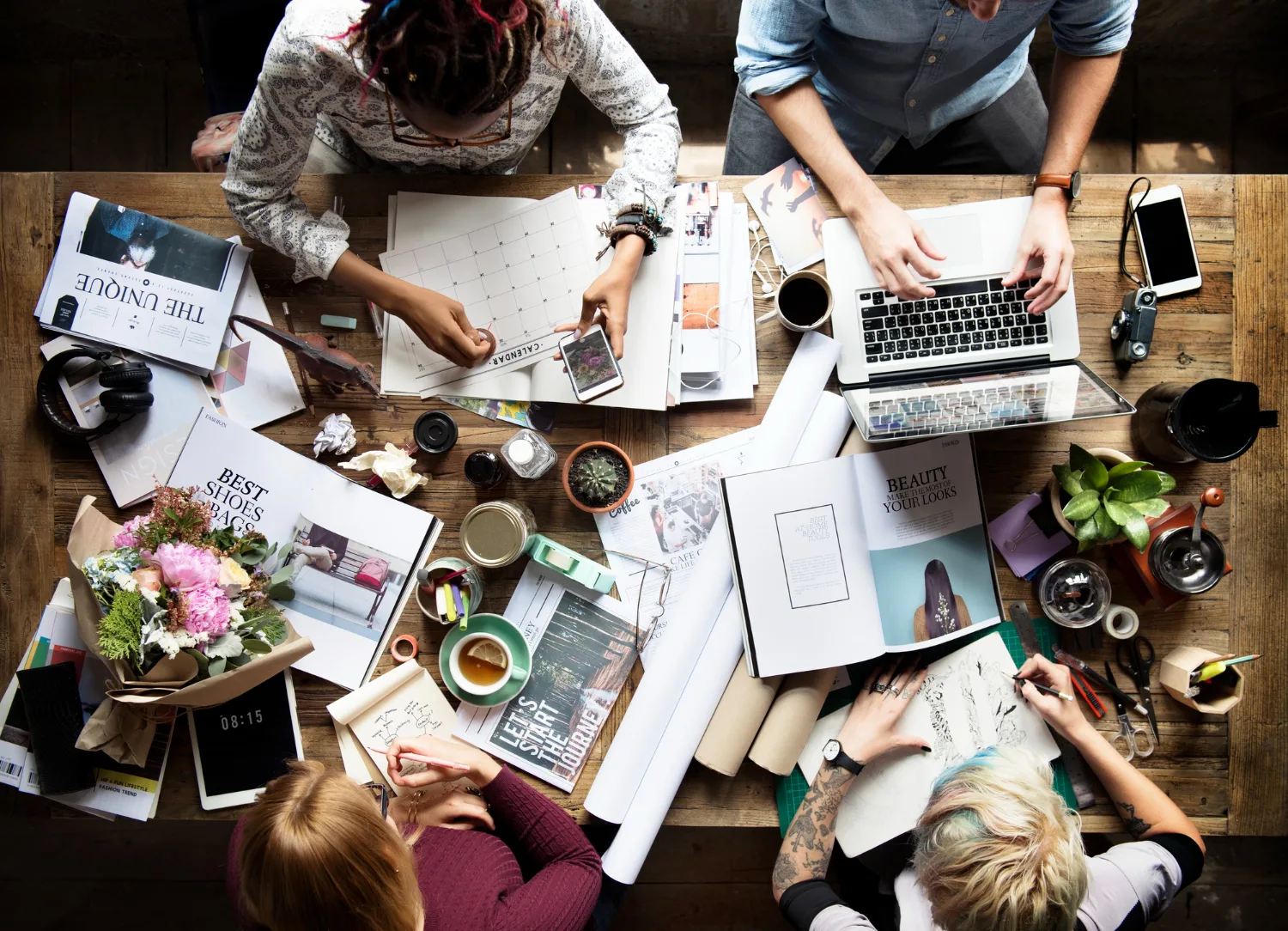 A creative team planning and producing digital work around a shared table